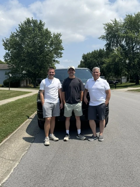 The family owners of Affordable Blinds Indy standing together outdoors